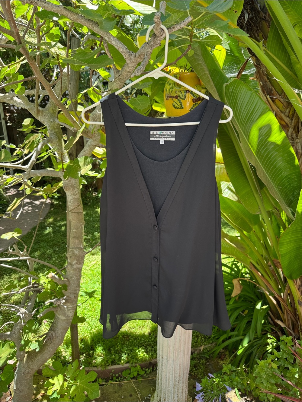 Sleeveless blouse with flowy overlay
